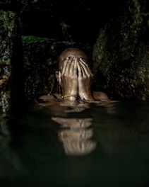 woman on water covering her face with both hands