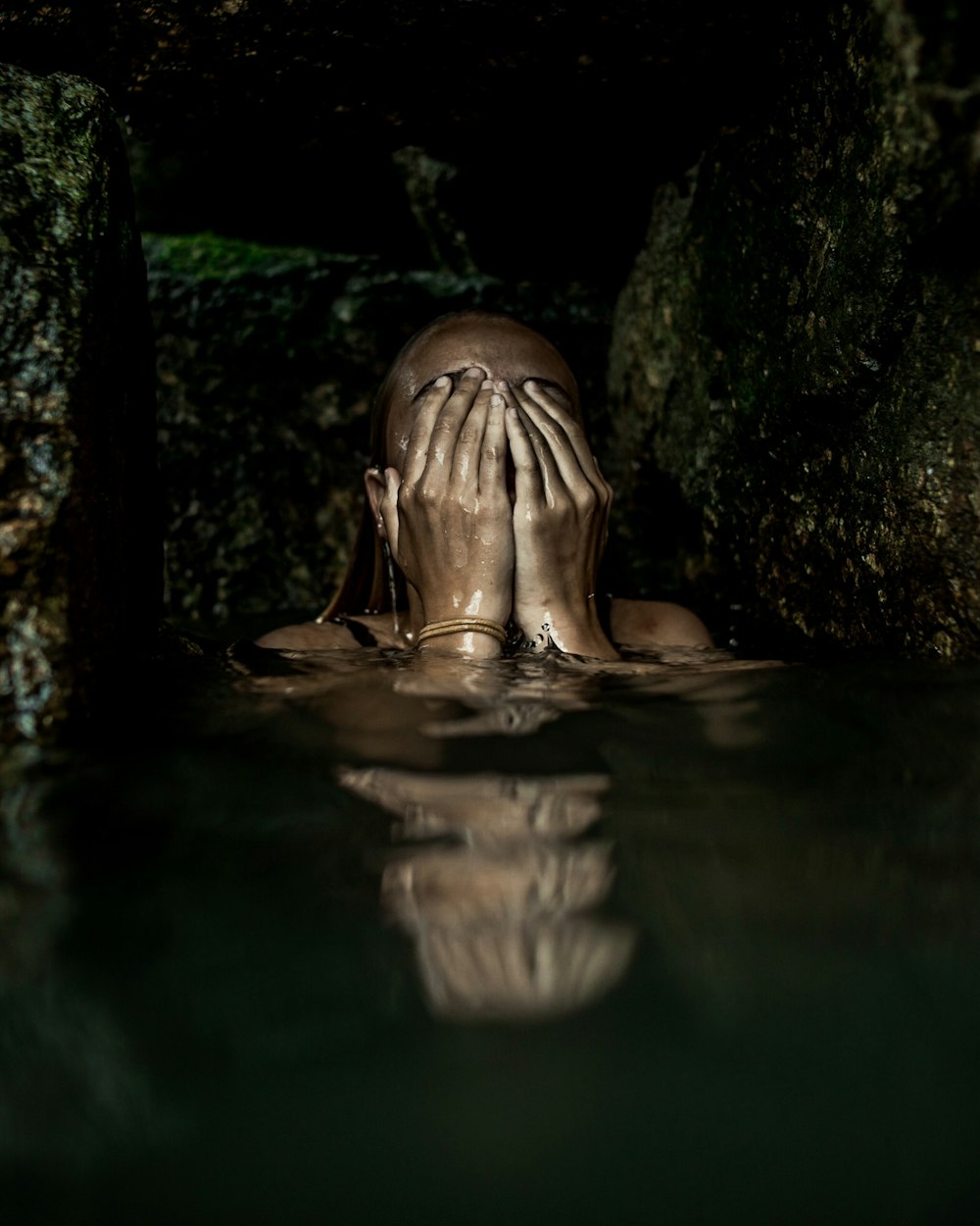 woman on water covering her face with both hands