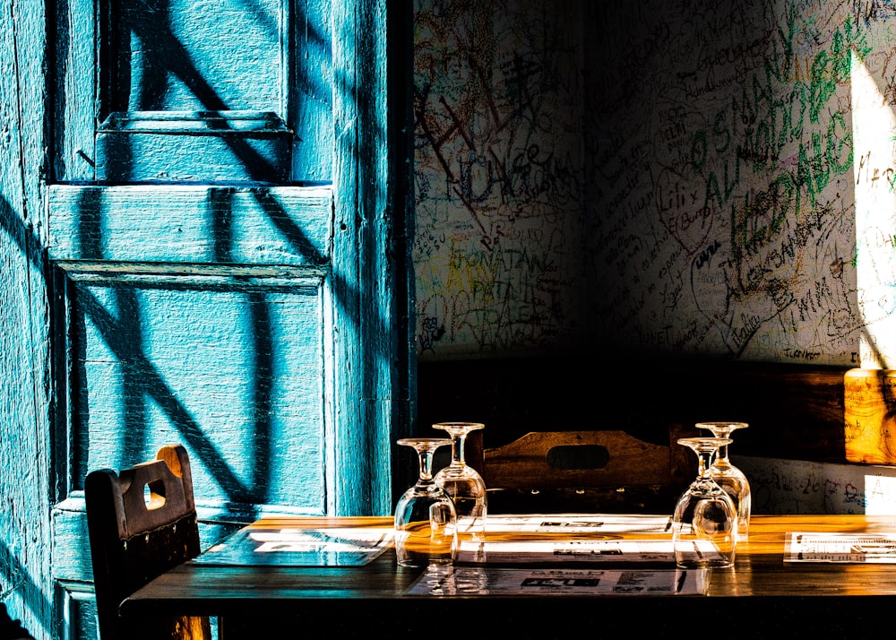 photography of brown table with drinking glasses