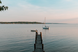 A peaceful lake scene in Carroll County, with a wooden dock and a small boat resting on the water.
