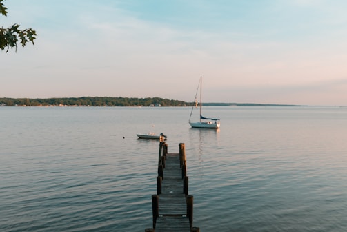 A peaceful lake scene in Carroll County, with a wooden dock and a small boat resting on the water.