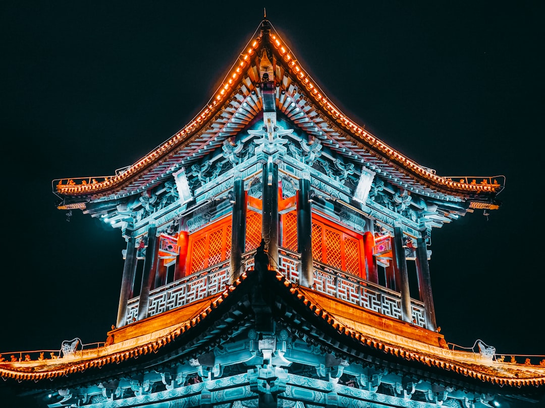 lighted pagoda temple at night time