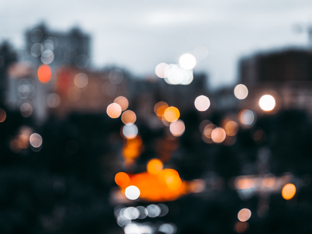 bokeh light photography of orange, white, and yellow lights