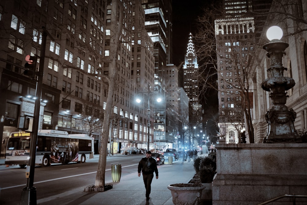 person walking on street in between builsing