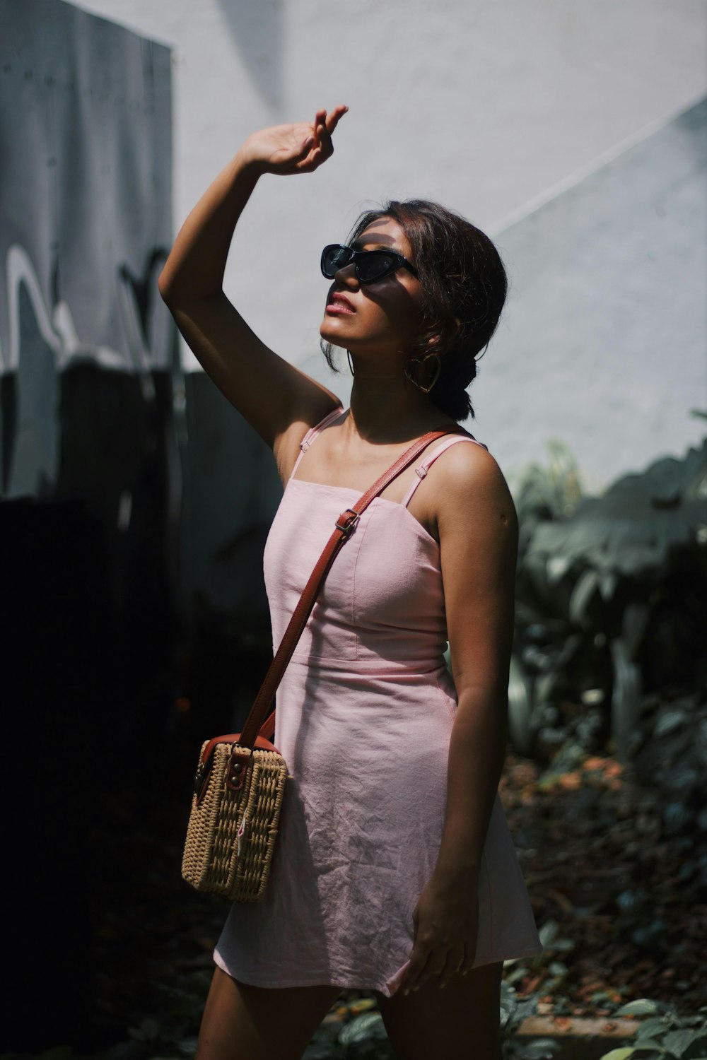 woman wearing sunglasses and wearing sling bag