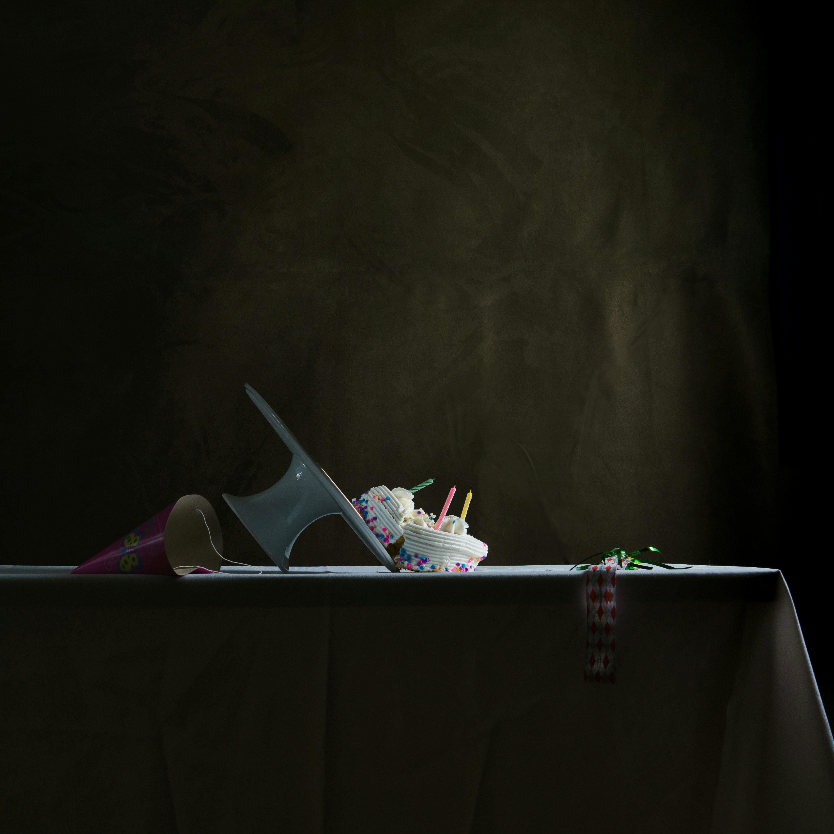 I wanted a serious–gloomy, even–formal picture of a cake that had slid off its cake plate. It does symbolize how sugar has fallen from grace in recent years, but it could really depict any formerly adored thing that’s gotten knocked off its high horse.