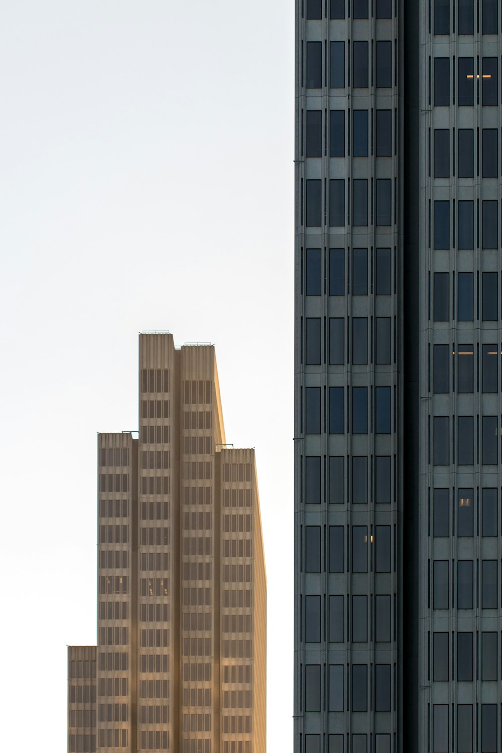 grey and black high rise buildings under white clouds