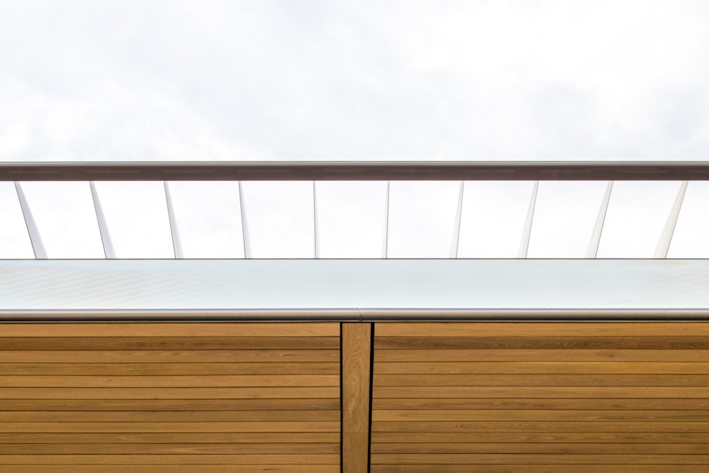 a close up of a wooden cabinet with a sky background