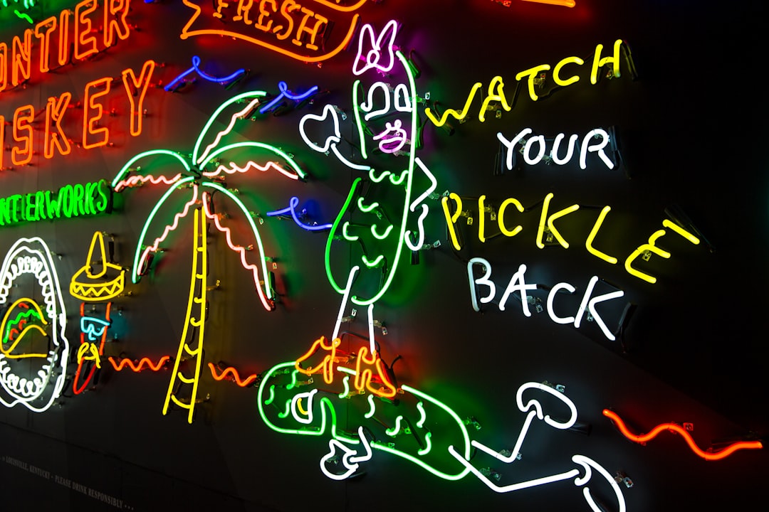 assorted neon signs mounted on black painted wall