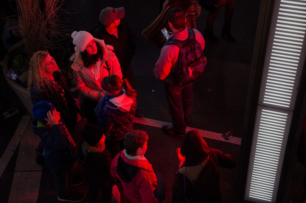 people gathering near red light