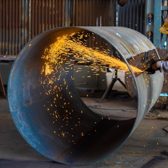 man wearing yellow hard hat holding angle grinder