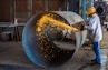 man wearing yellow hard hat holding angle grinder