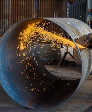 man wearing yellow hard hat holding angle grinder