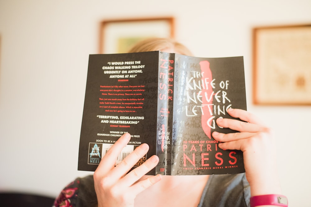 person holding The Knife of Never Letting Go book