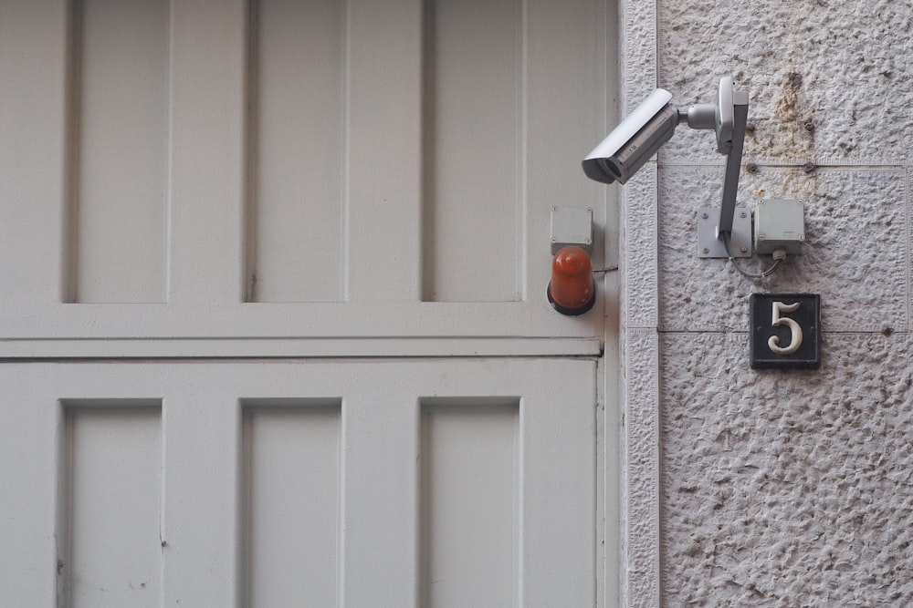 white wooden door near gray security camera