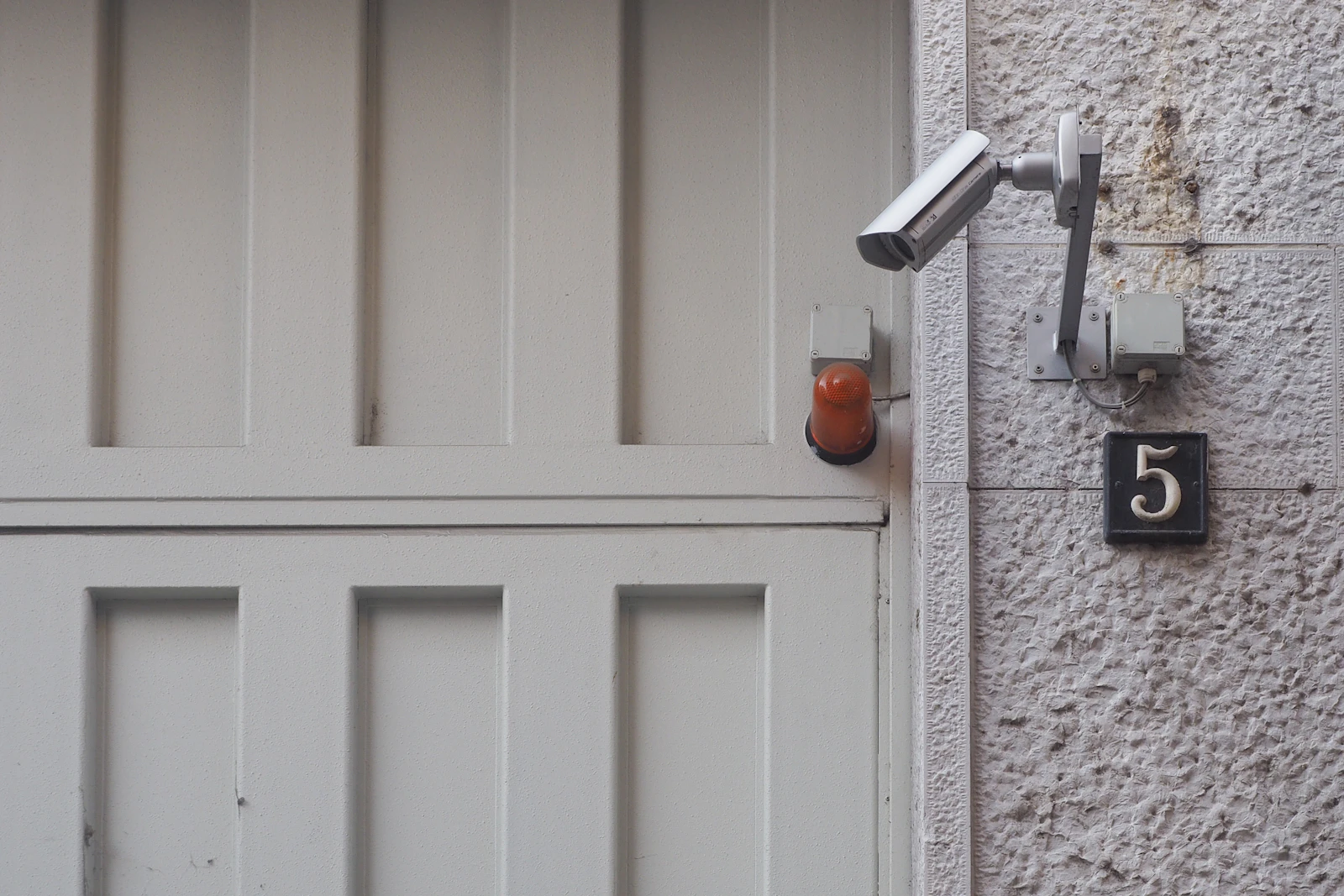 Security camera keeping watch over a property entrance