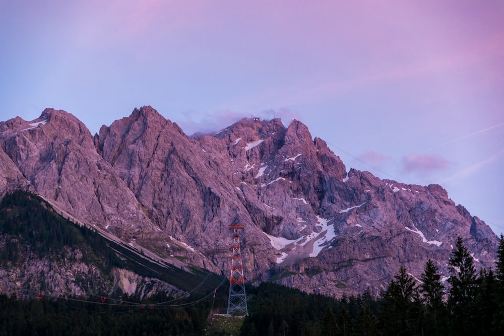 photo of grey rocky mountain under cloudy blue sky