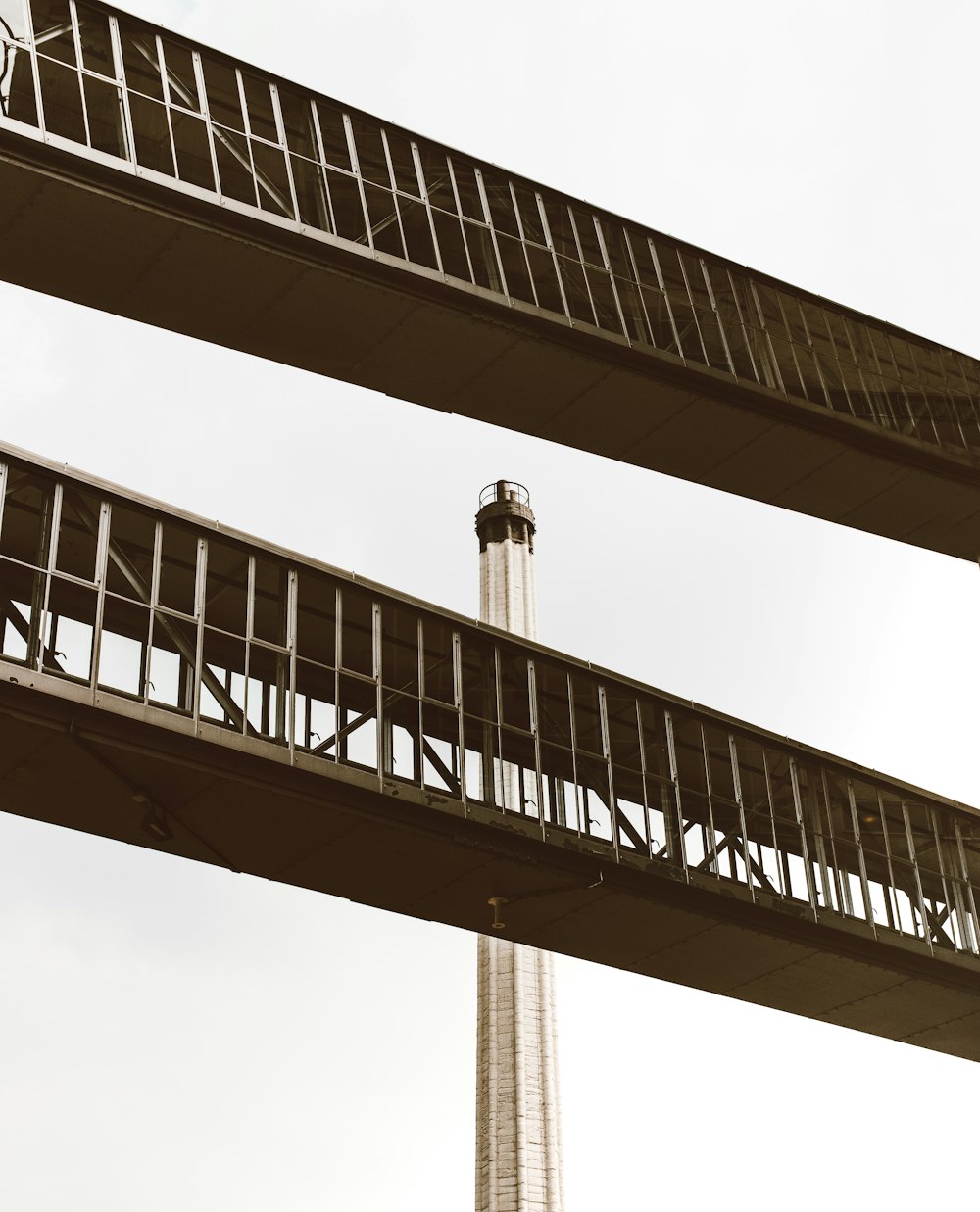 white tower behind two foot bridges