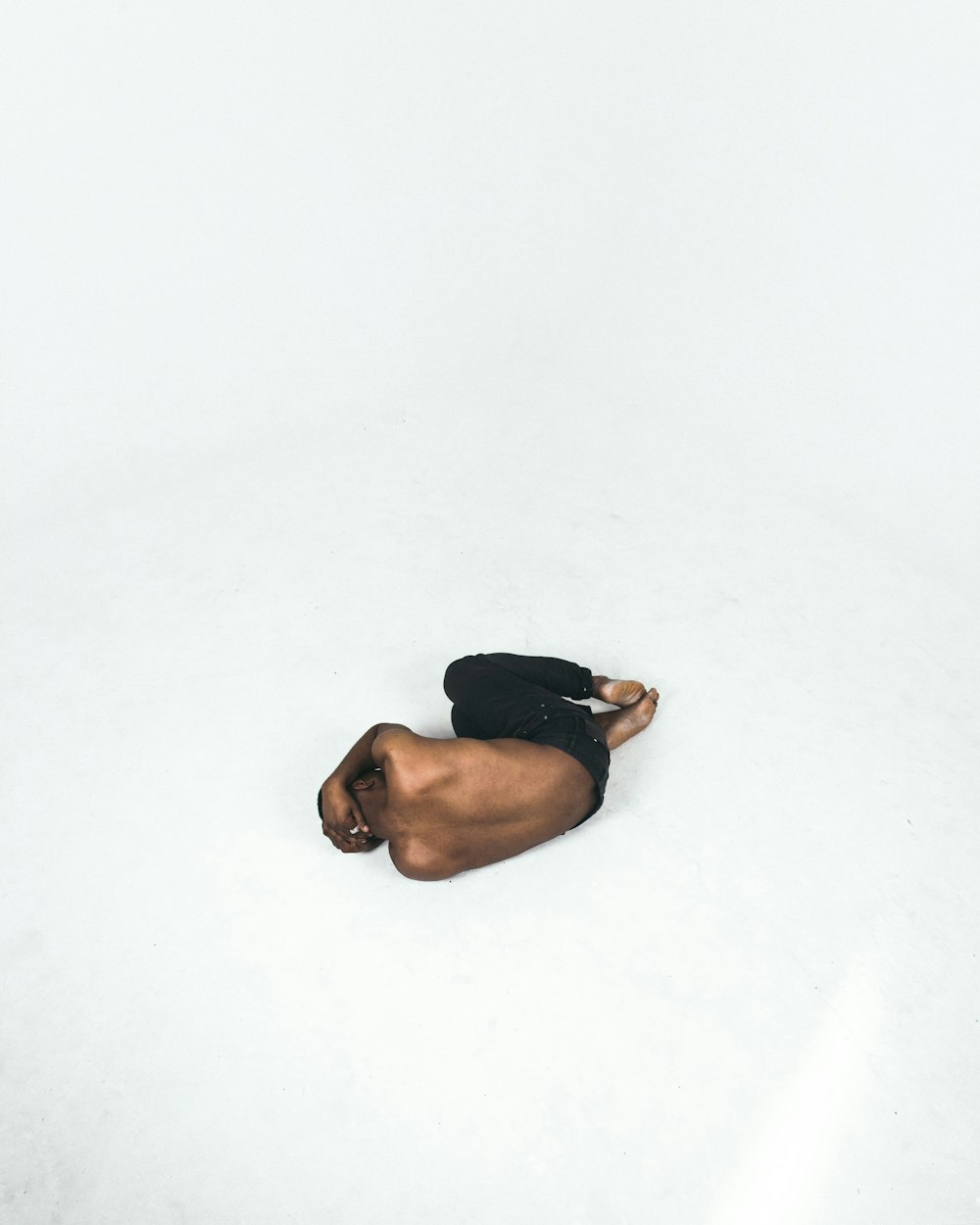 person lying down on white surface