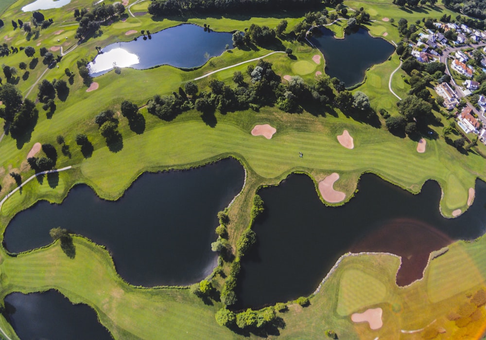 an aerial view of a golf course surrounded by water