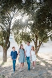 family standing in front of trees