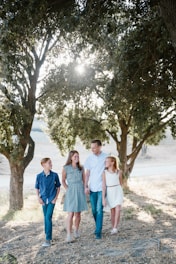 family standing in front of trees