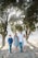 family standing in front of trees