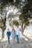 family standing in front of trees