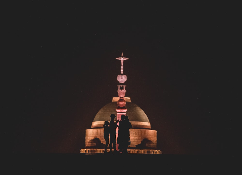 silhouette of family standing near building