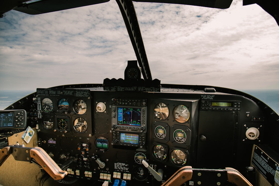 person taking photo of airplane navigation system, Above Bolivia