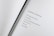 An open book with a poem titled 'Internal Bleeding' written on the right page. The text is centered and the page is mostly blank except for the poem, which discusses the concept that 'time heals all wounds' is a fallacy.