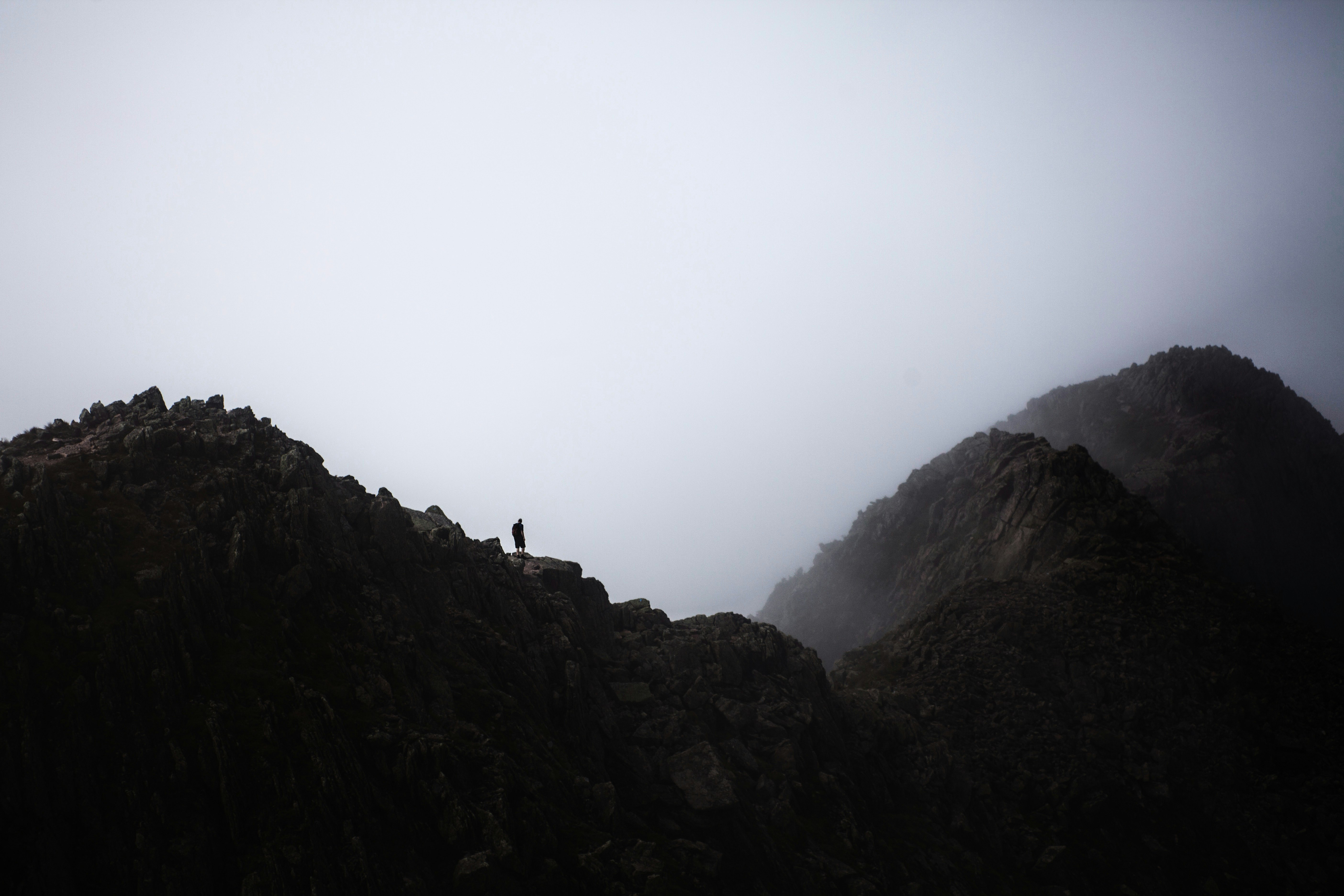 silhouette photography of person on cliff