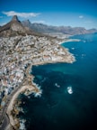 city beside body of water and mountains