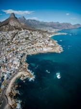 city beside body of water and mountains