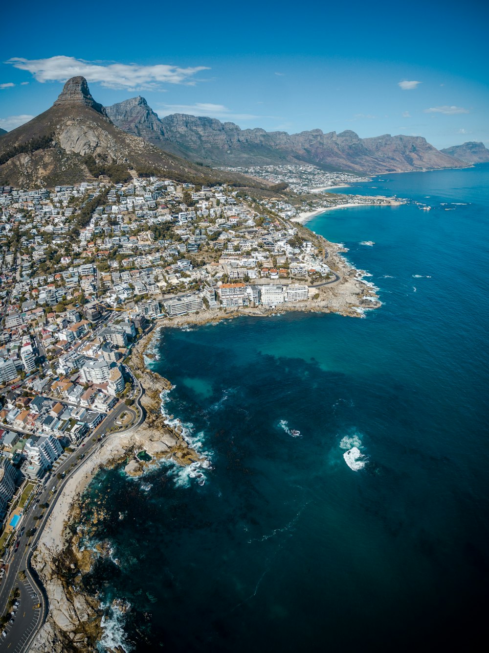 city beside body of water and mountains