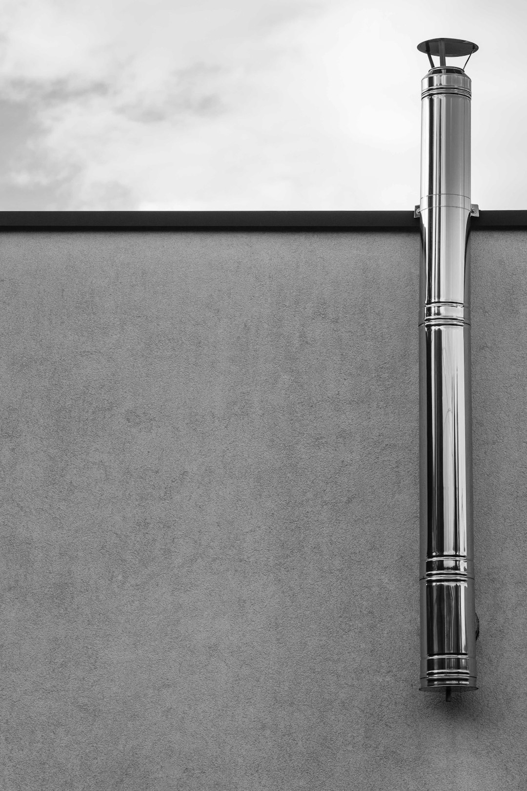  grayscale photography of tube chimney