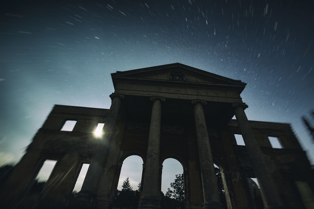 timelapes photography of stars over white concrete pillar