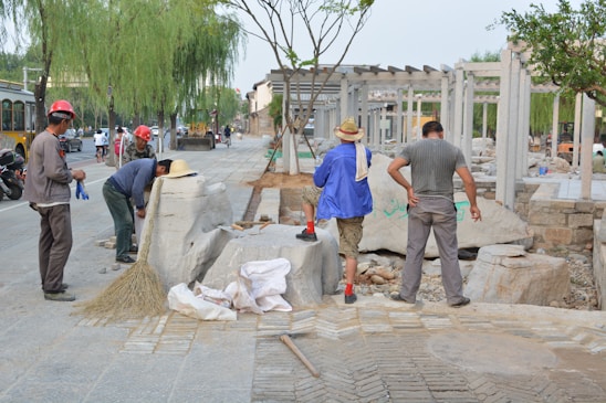 A diverse group of apprentices engaged in hands-on training at a construction site.