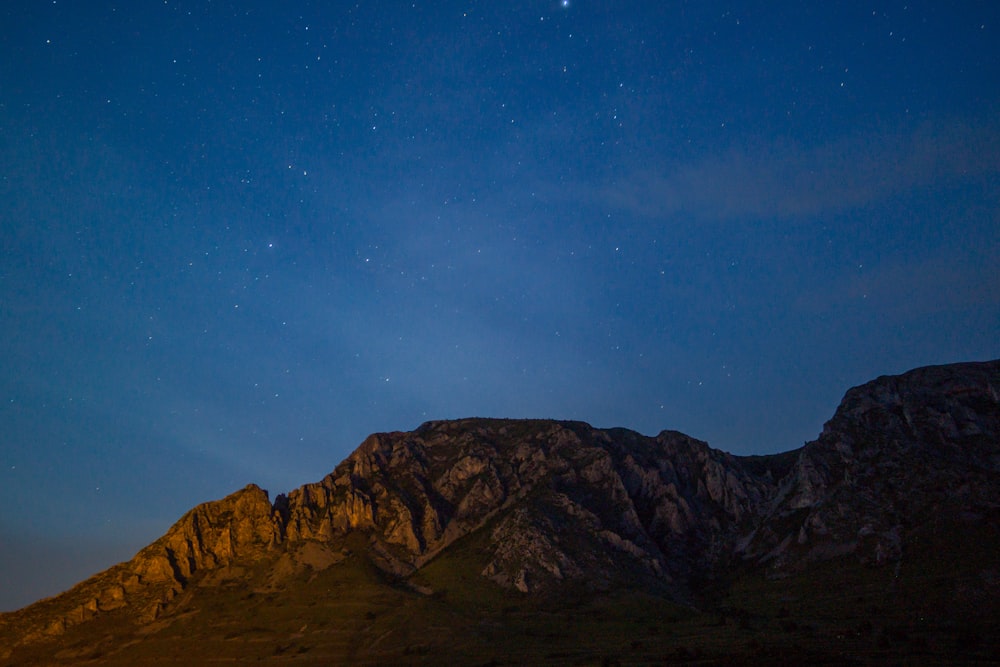 gray mountain under clear blue sky