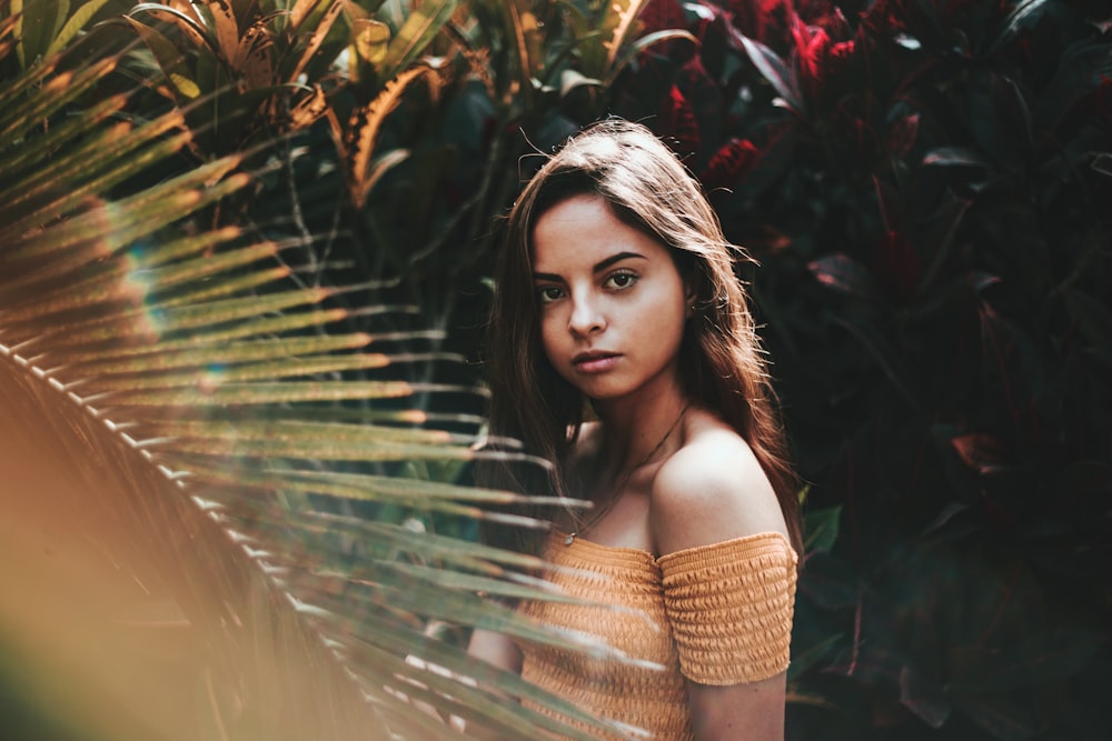 woman standing near green plant outside