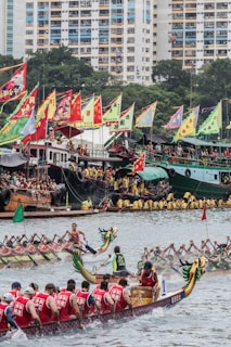 group of people riding dragon boat on water