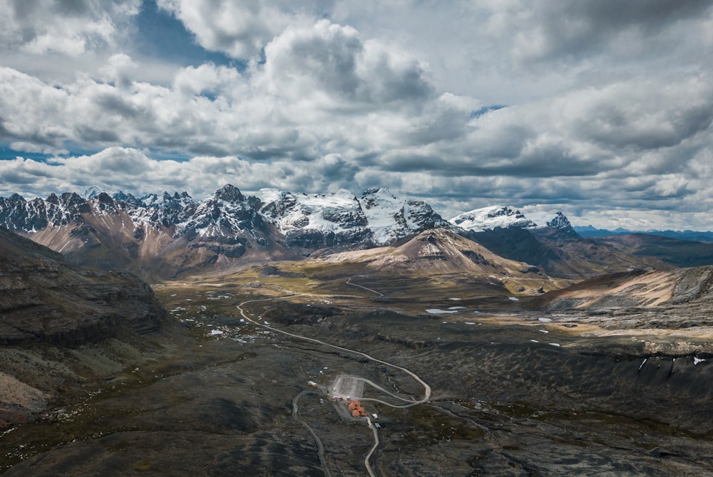 aerial photo of mountain under cloudy sky