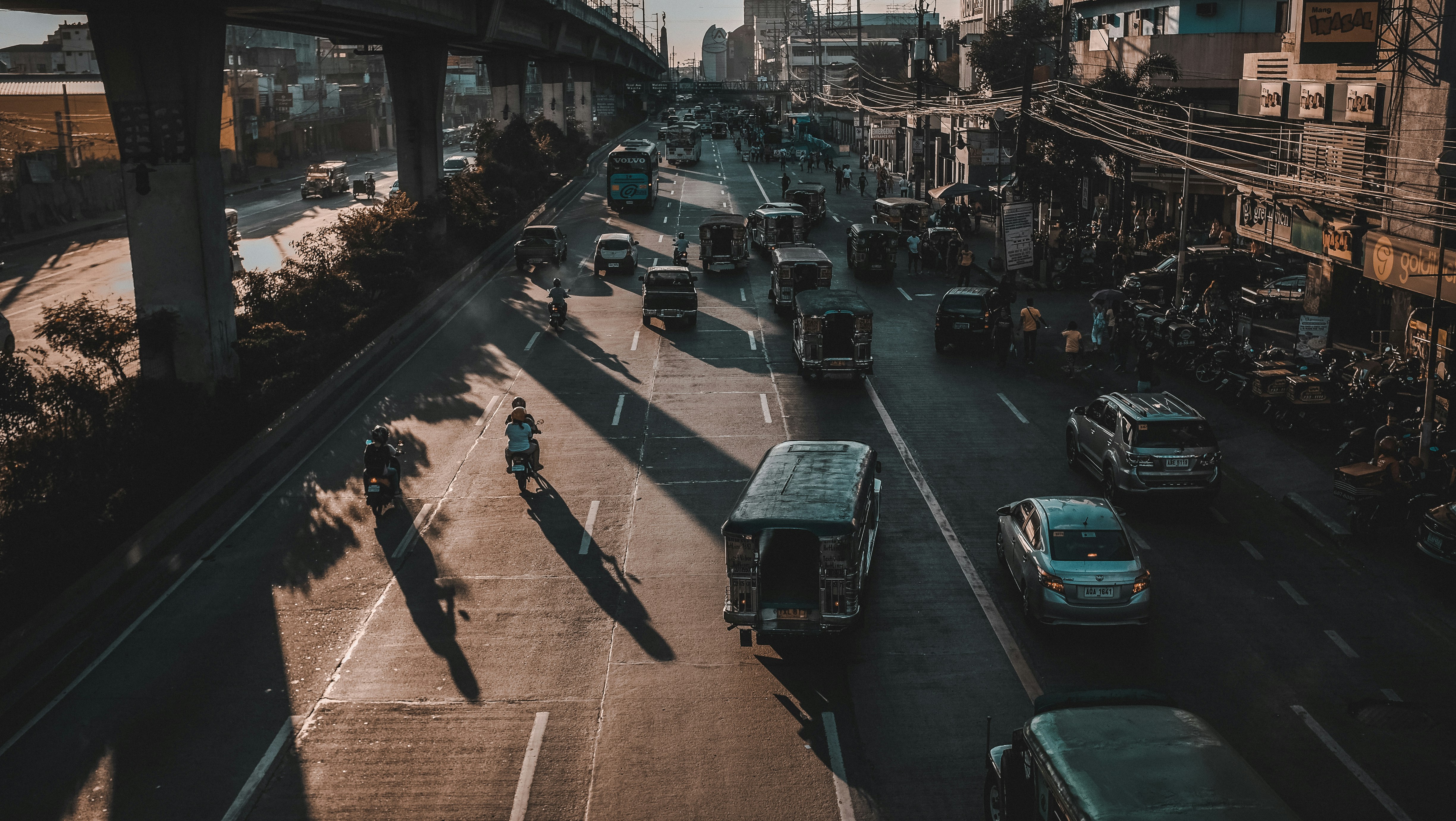 assorted-color vehicles on road during daytime