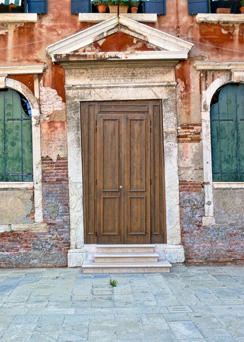 white and brown concrete building with door and windows