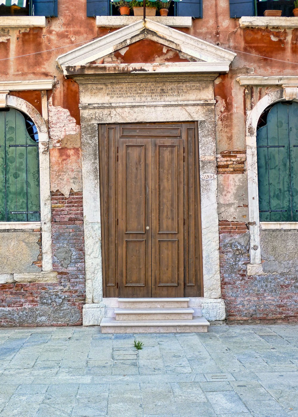 Bâtiment en béton blanc et brun avec porte et fenêtres
