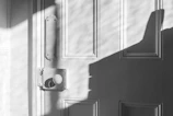 An artistic black and white photo of an old rustic door.