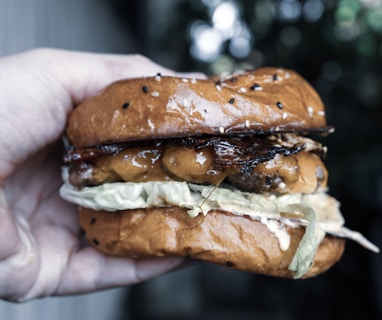 person holding burger with meat