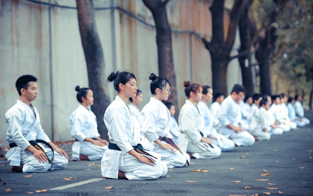 group of martial artists sitting on the grounds