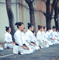 group of martial artists sitting on the grounds