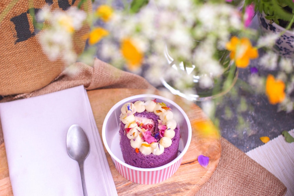purple and white icing cake on white ramekin bowl